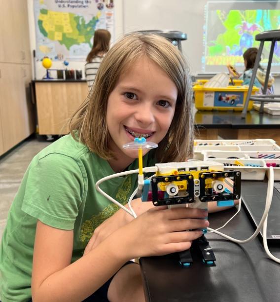 Girl who is a student holding a project she made