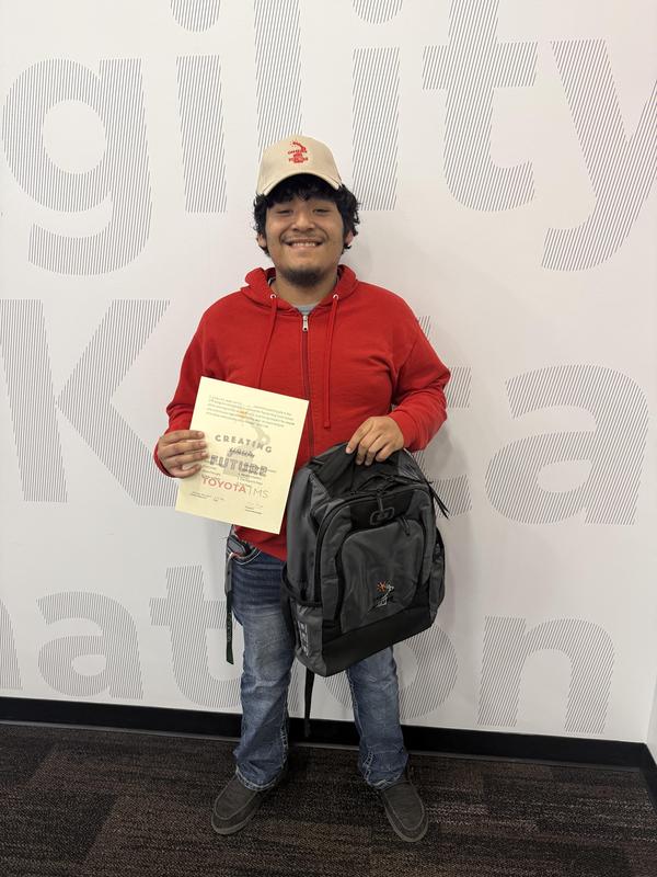 Uzzy holding a certificate.