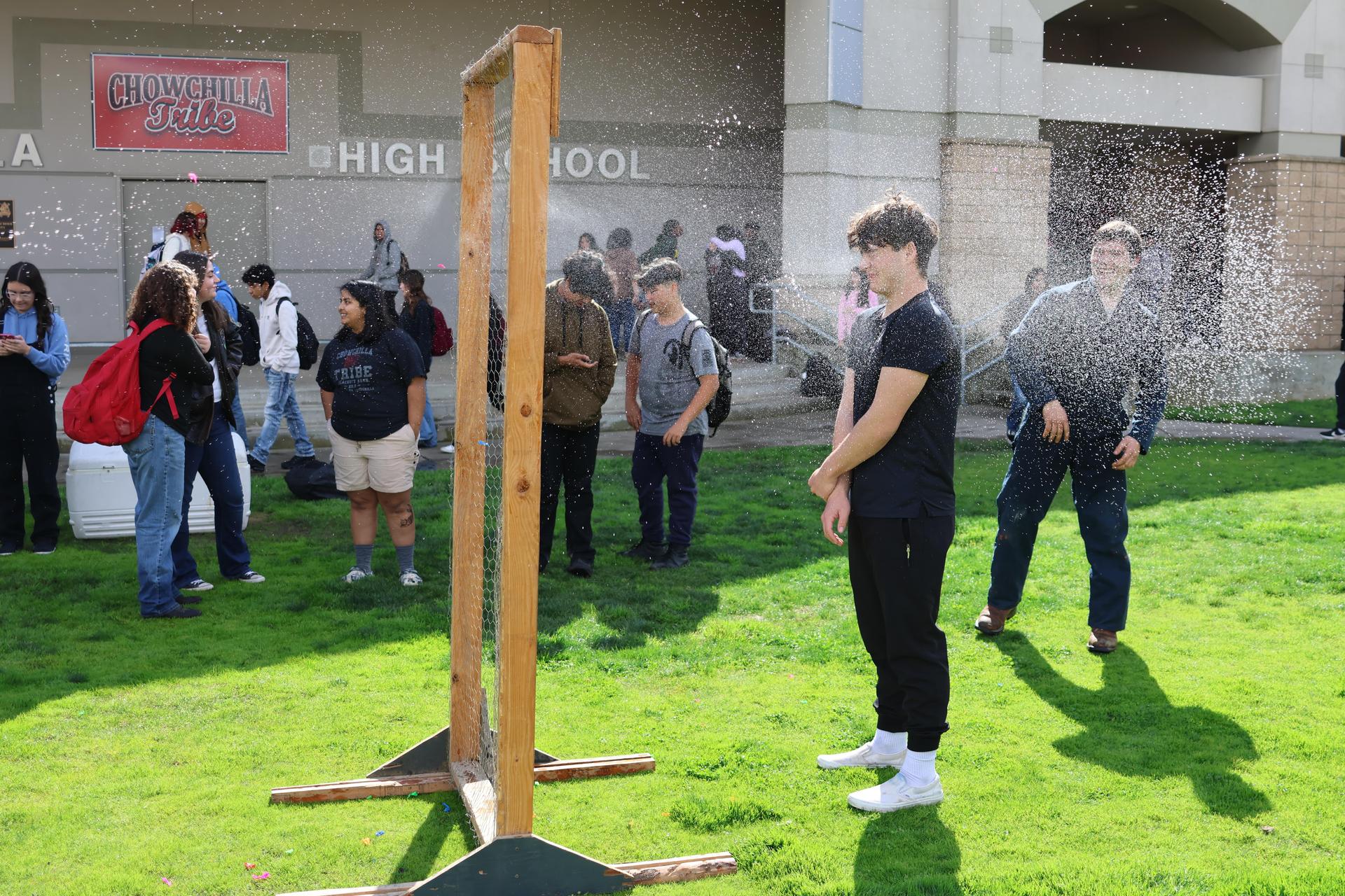 students and staff enjoying the water balloon toss