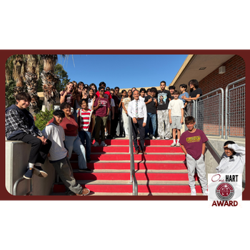 A teacher and students standing on a staircase