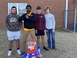 Boys standing with their pinata.
