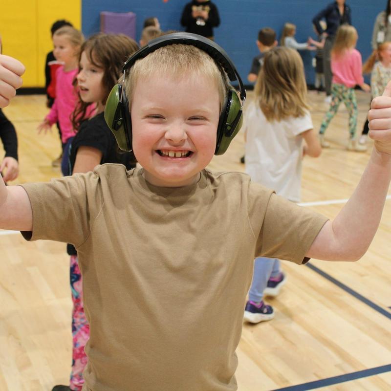 boy with big smile on face in gym