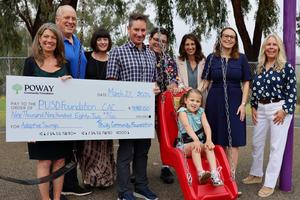 photo of members of poway community foundation and poway unified holding check