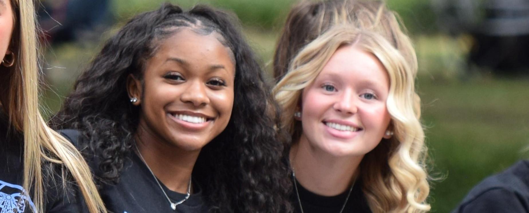 High school girls smiling in a parade
