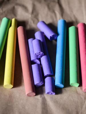Colorful chalk pieces laid out on a surface.