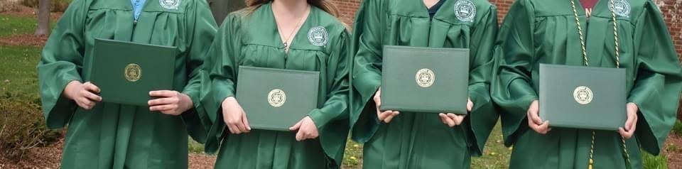 Four college students holding diplomas