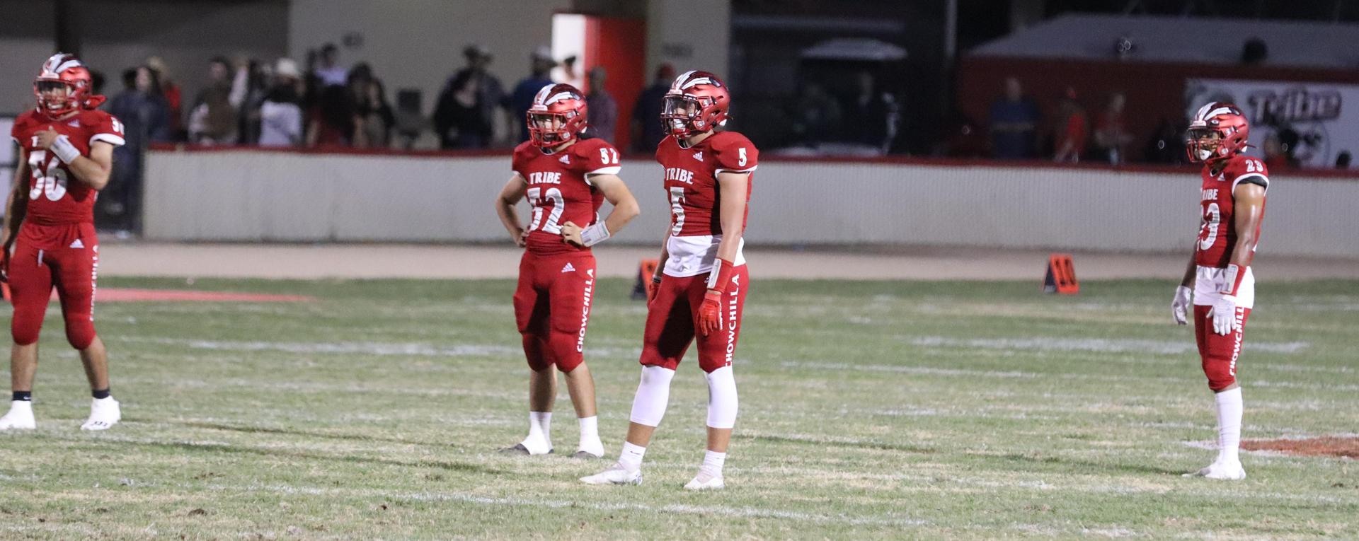 varsity football players in action against Riverdale