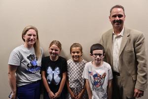 Sanford Principal Kristi Odom and students from the campus announcements team pose for a picture with Dr. Brown after leading the pledge of allegiance.
