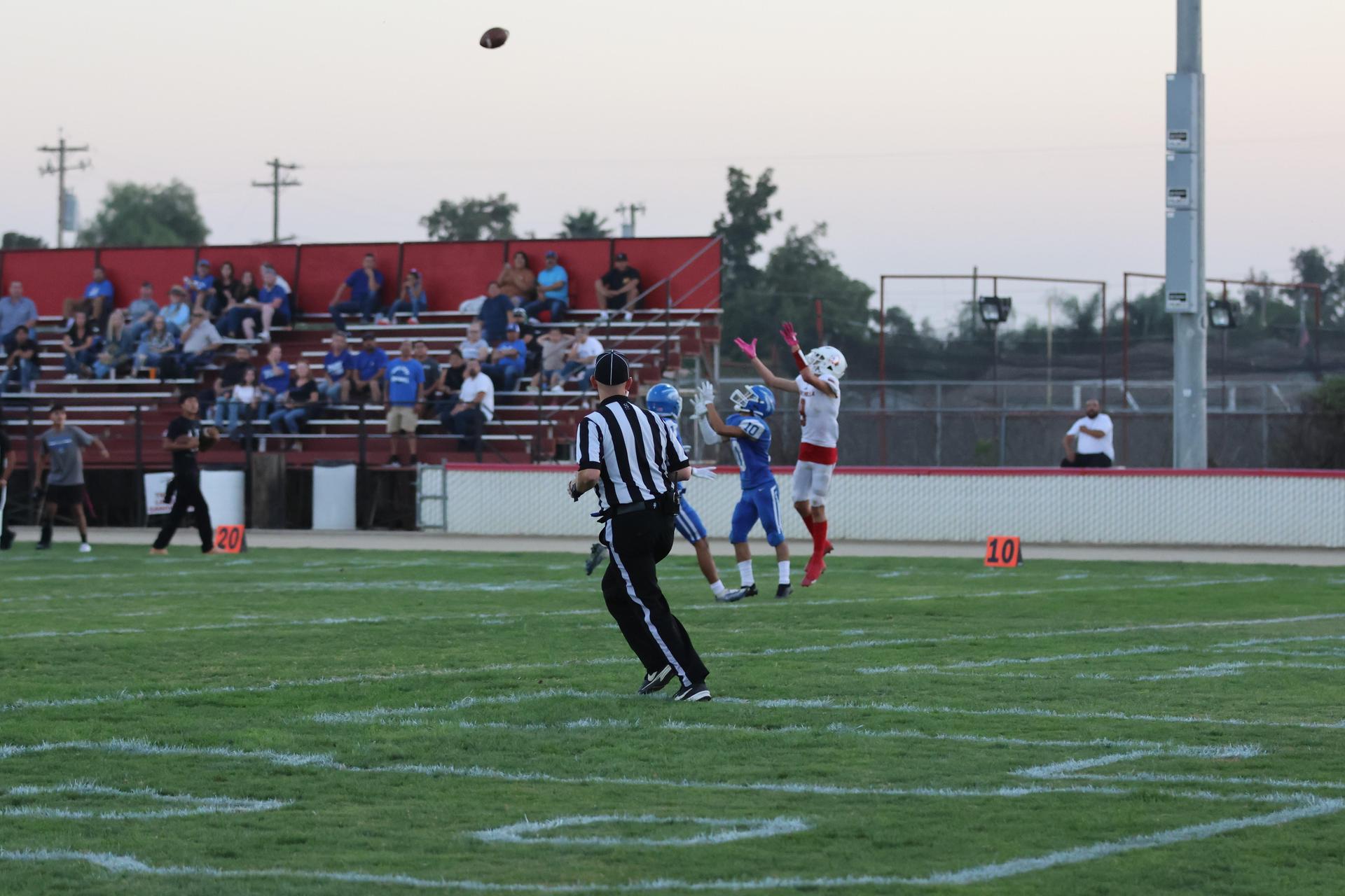 Junior Varsity football players in action against Caruthers