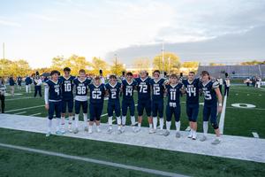 group of football players standing on football field