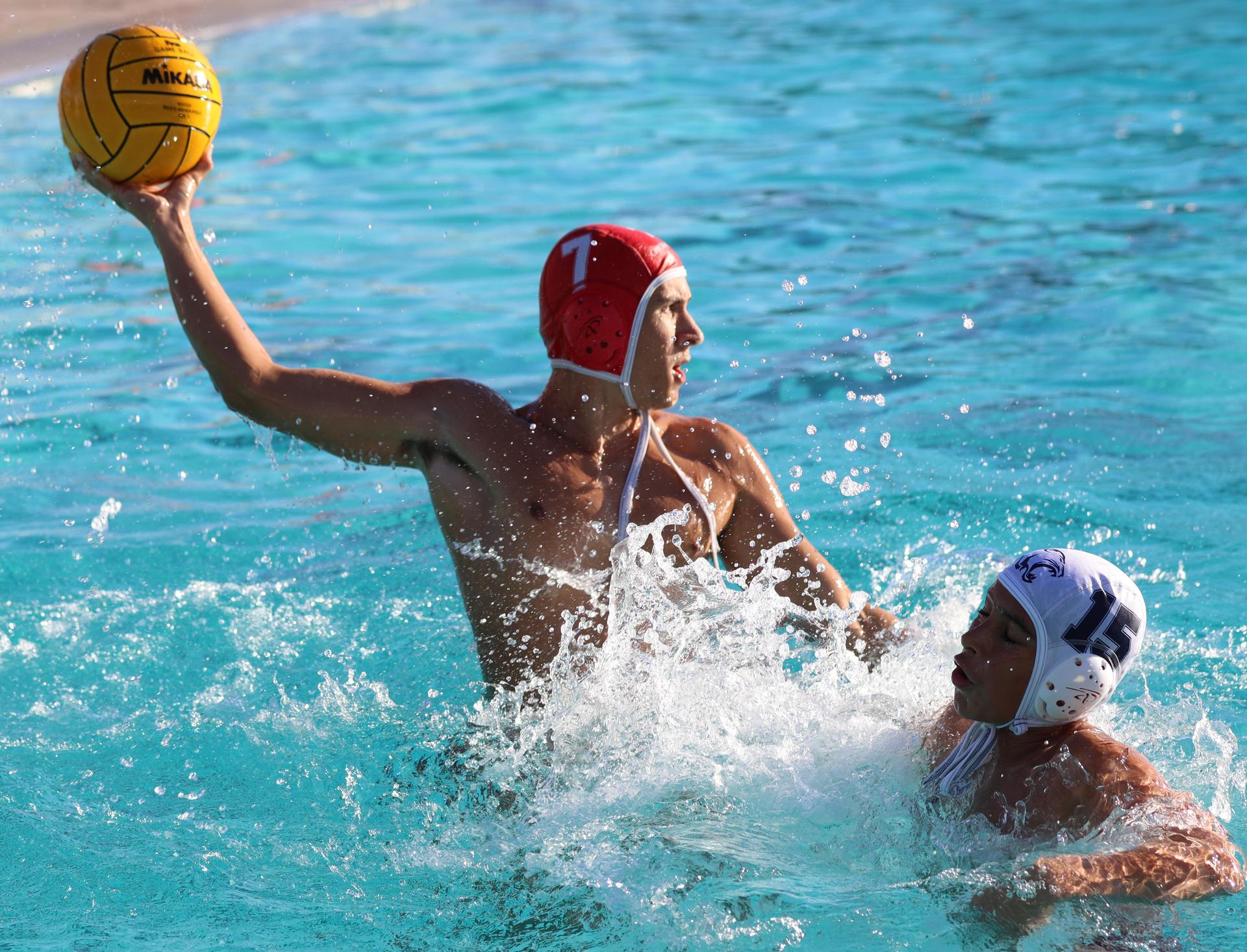 boys water polo players in action against san joaquin memorial