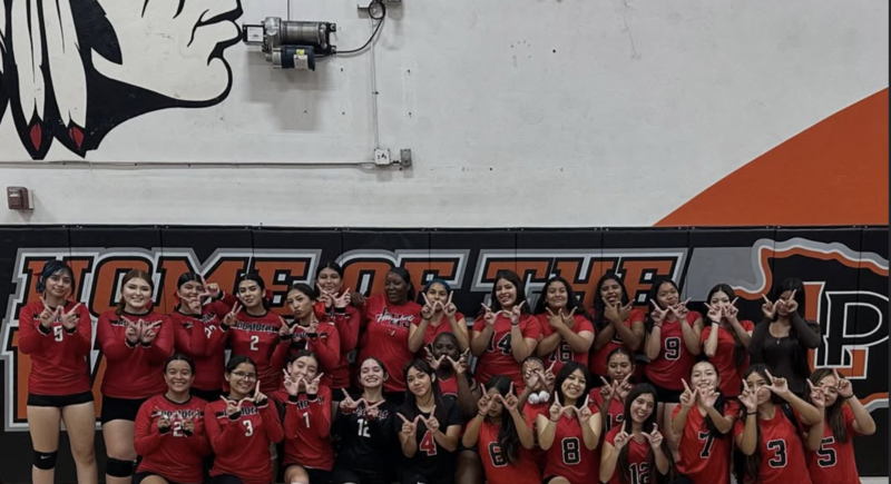 volleyball program showing W's with their fingers as the celebrate a big win