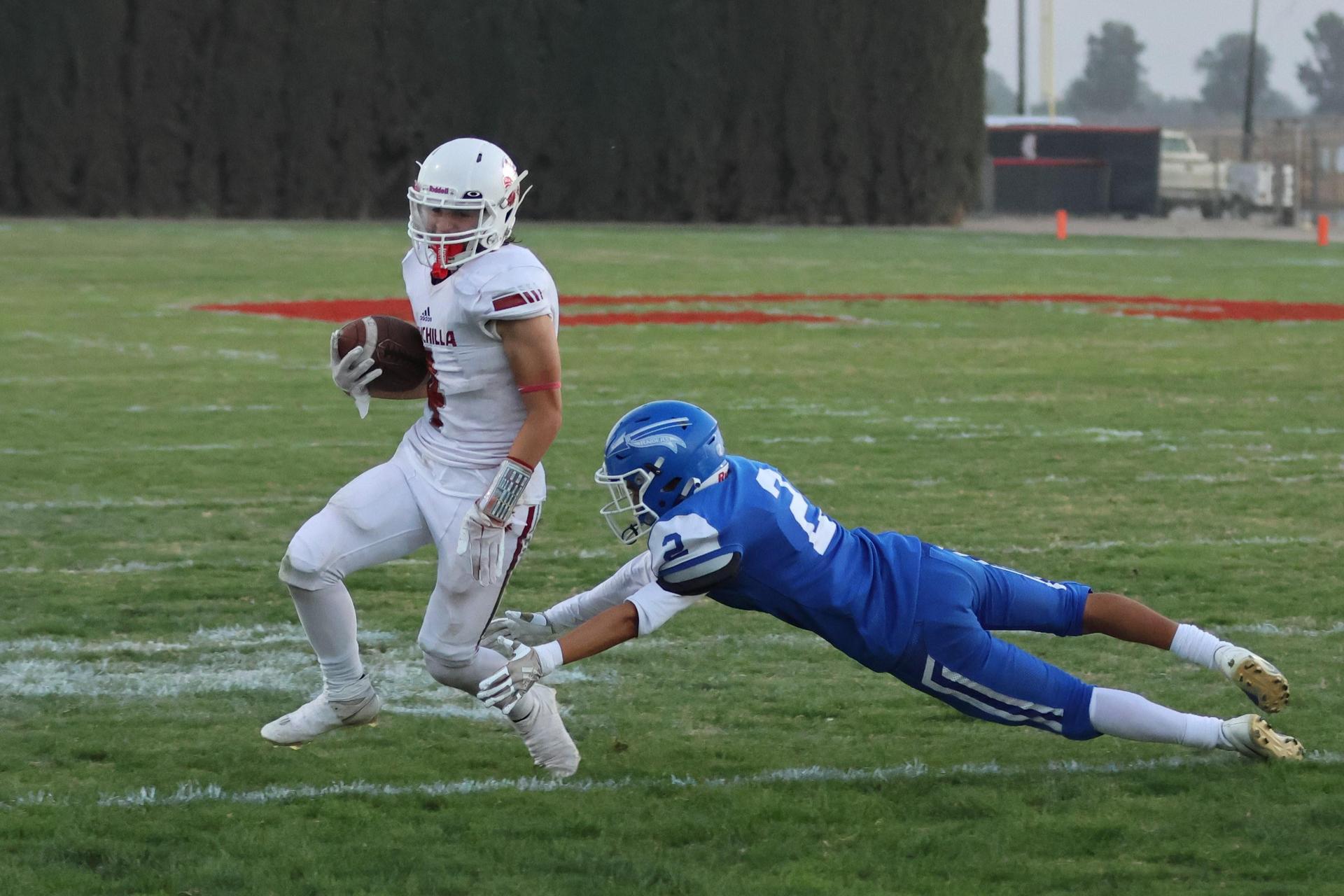 Junior Varsity football players in action against Caruthers