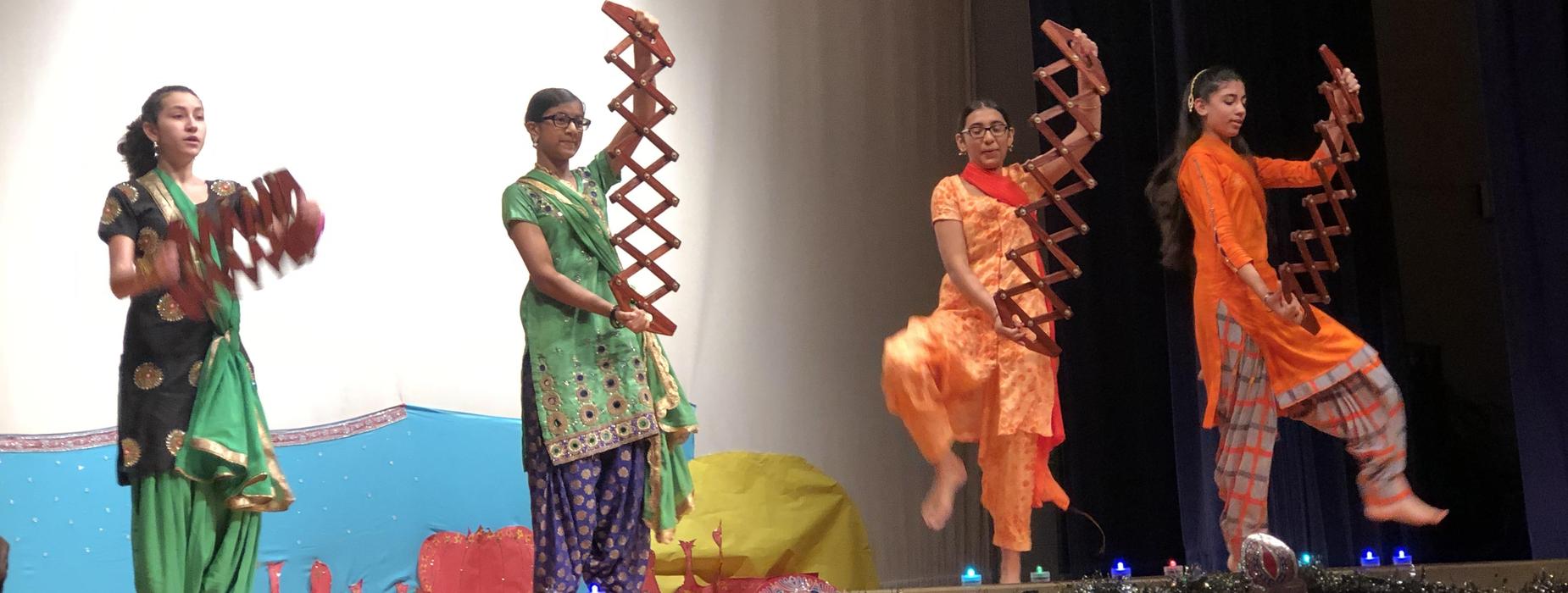 Students dance on stage.