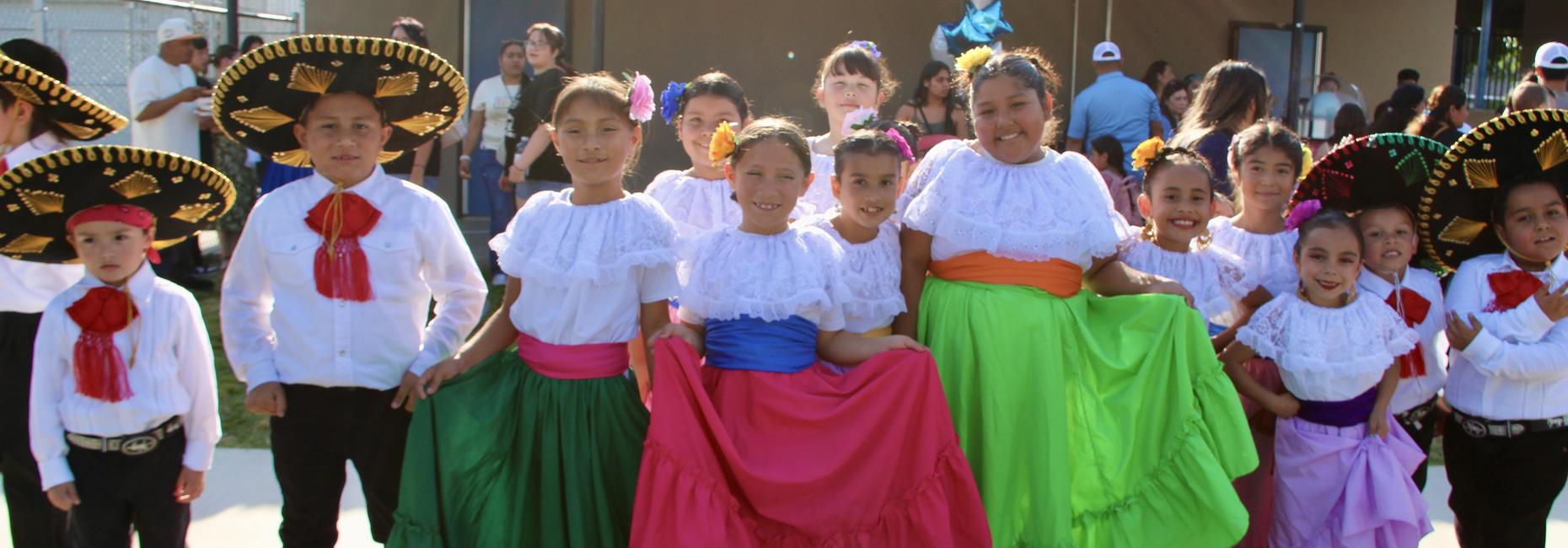 14 students in Ballet Folklorico attire for the Dia Del Nino dance presentation.