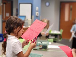 A student cuts out a doctor's bag