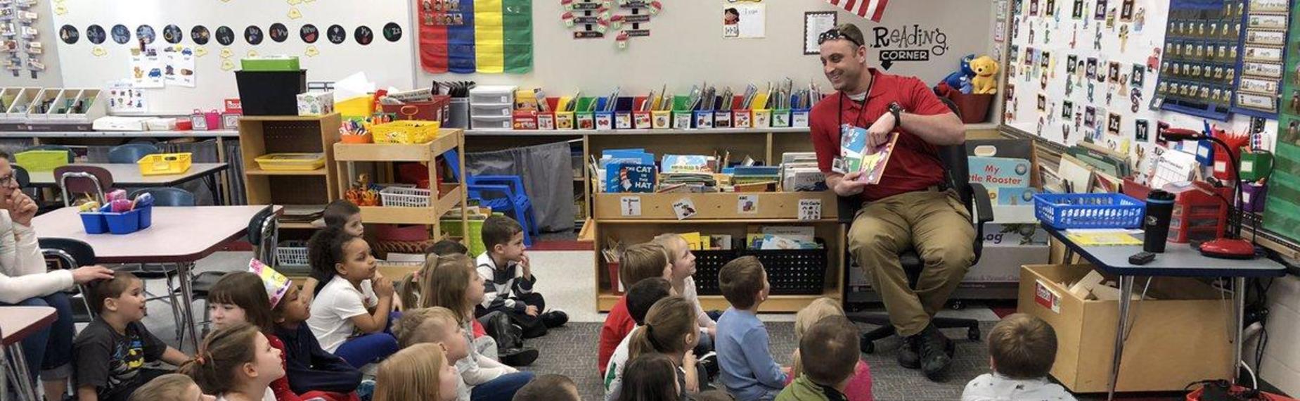 Resource Office Sean reading to students