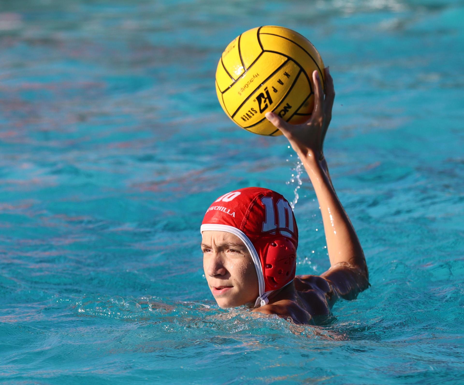 boys water polo players in action against hoover
