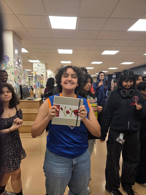 a happy student holding something