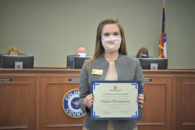 teacher holding certificate