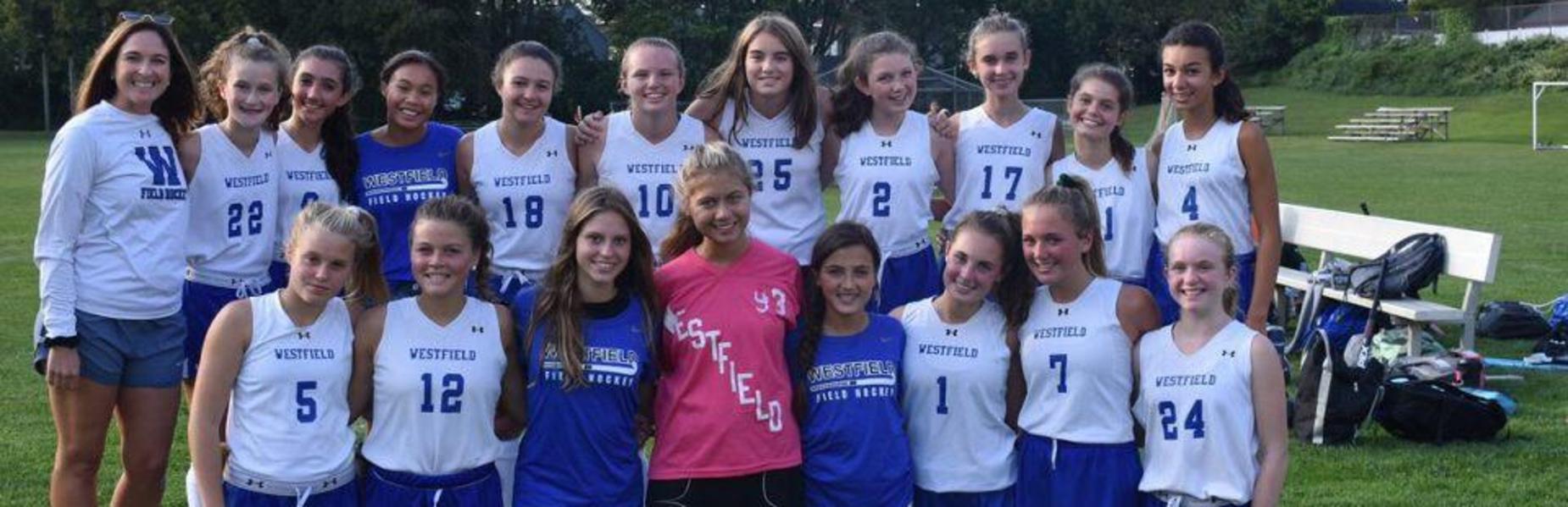 Photo of freshman girls field hockey team as coach celebrates her 100th win.
