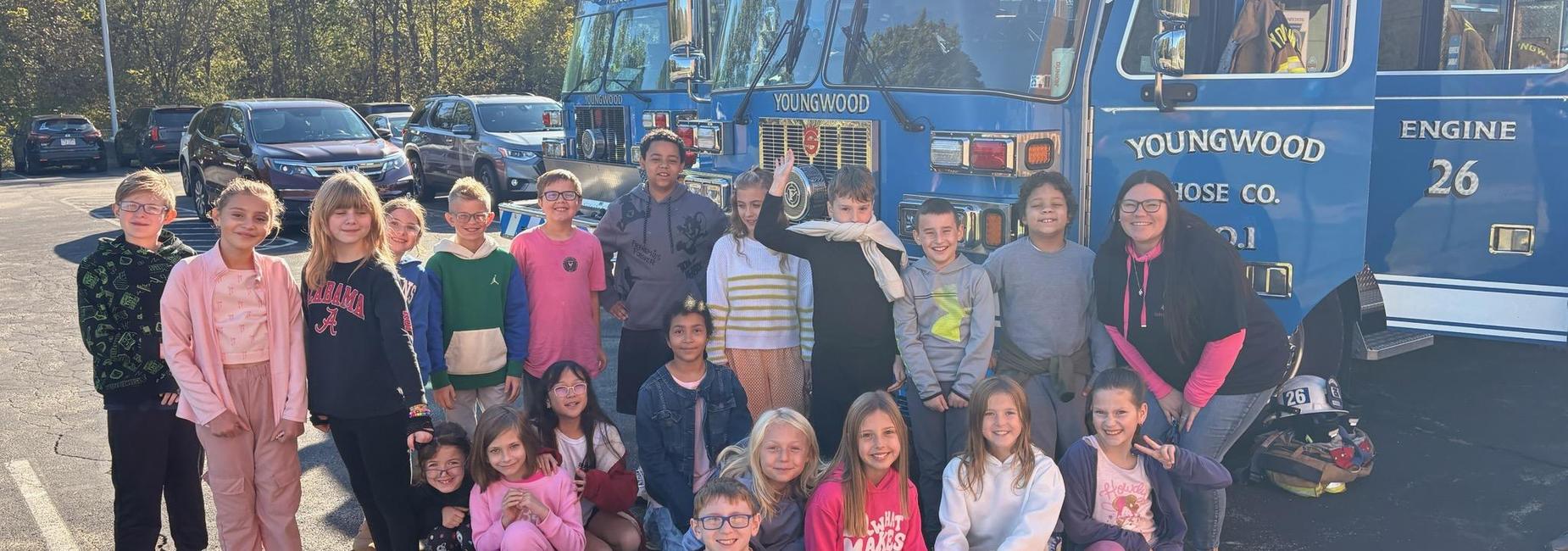 student posing in front of a fire truck
