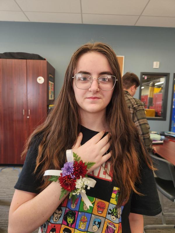 Lacinda Roser holding her hand showing off the corsage she made.