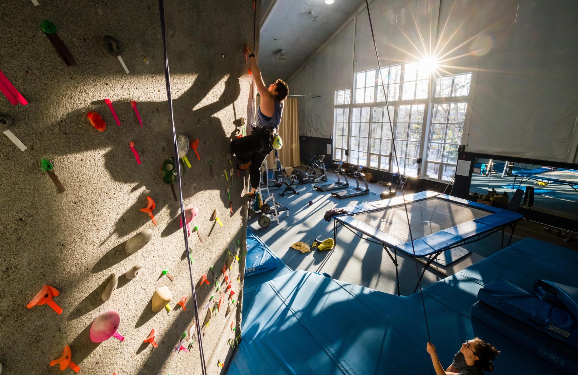 A student reaching the top of our climbing wall.