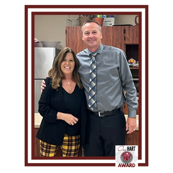 A woman and a man in a tie smiling