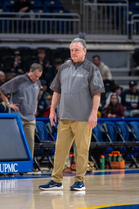 basketball coach standing on court in Knoch apparel