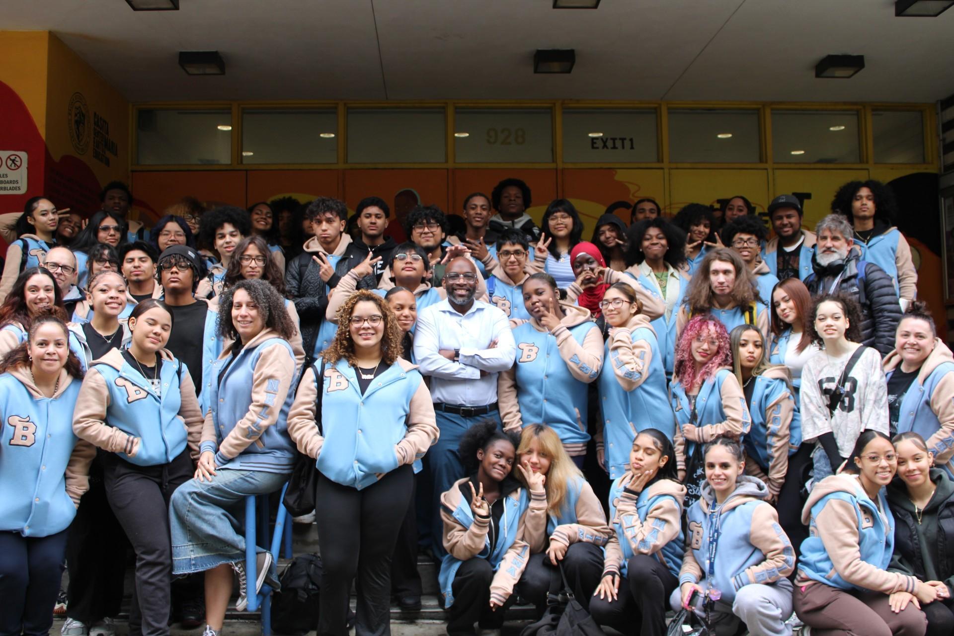 Class of 2026 students in front of school building.