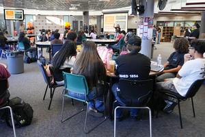students in SJHS library listening to a presentation.