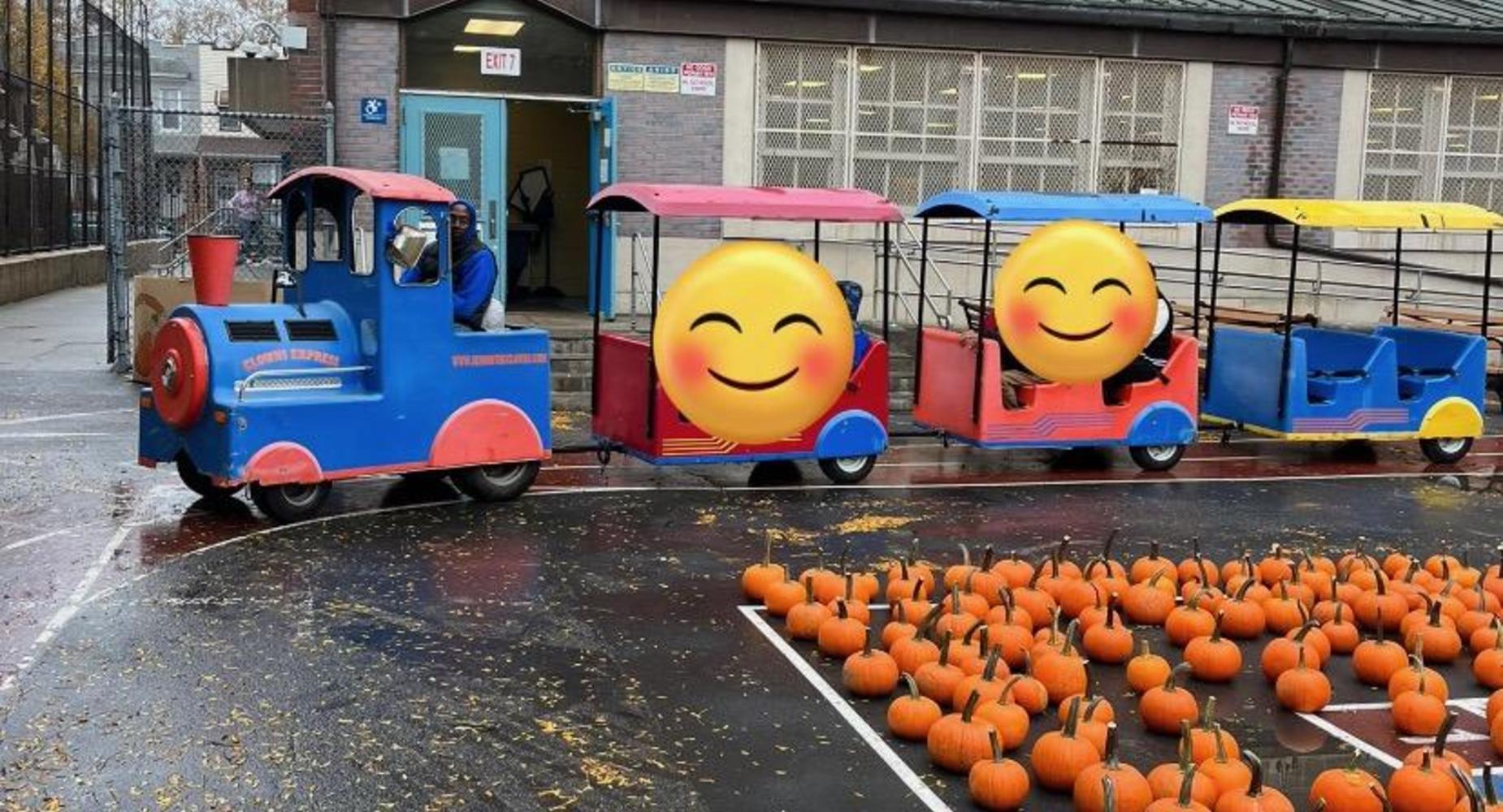 Blue train and pumpkins for picking the school yard