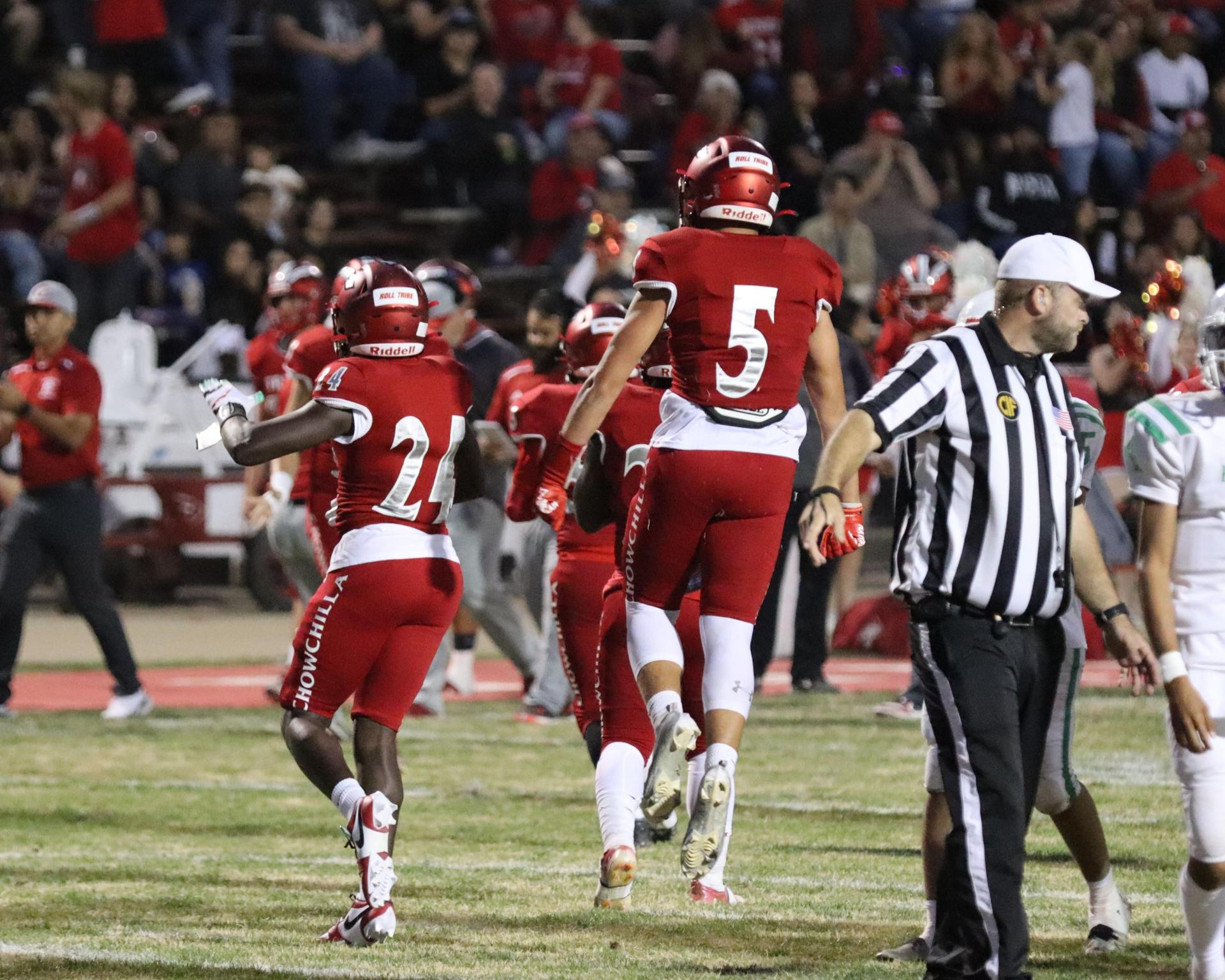 varsity football players in action against Riverdale