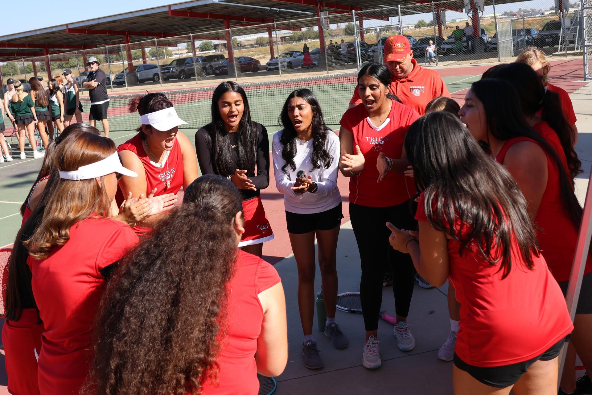 tennis players, family, and staff celebrating senior night
