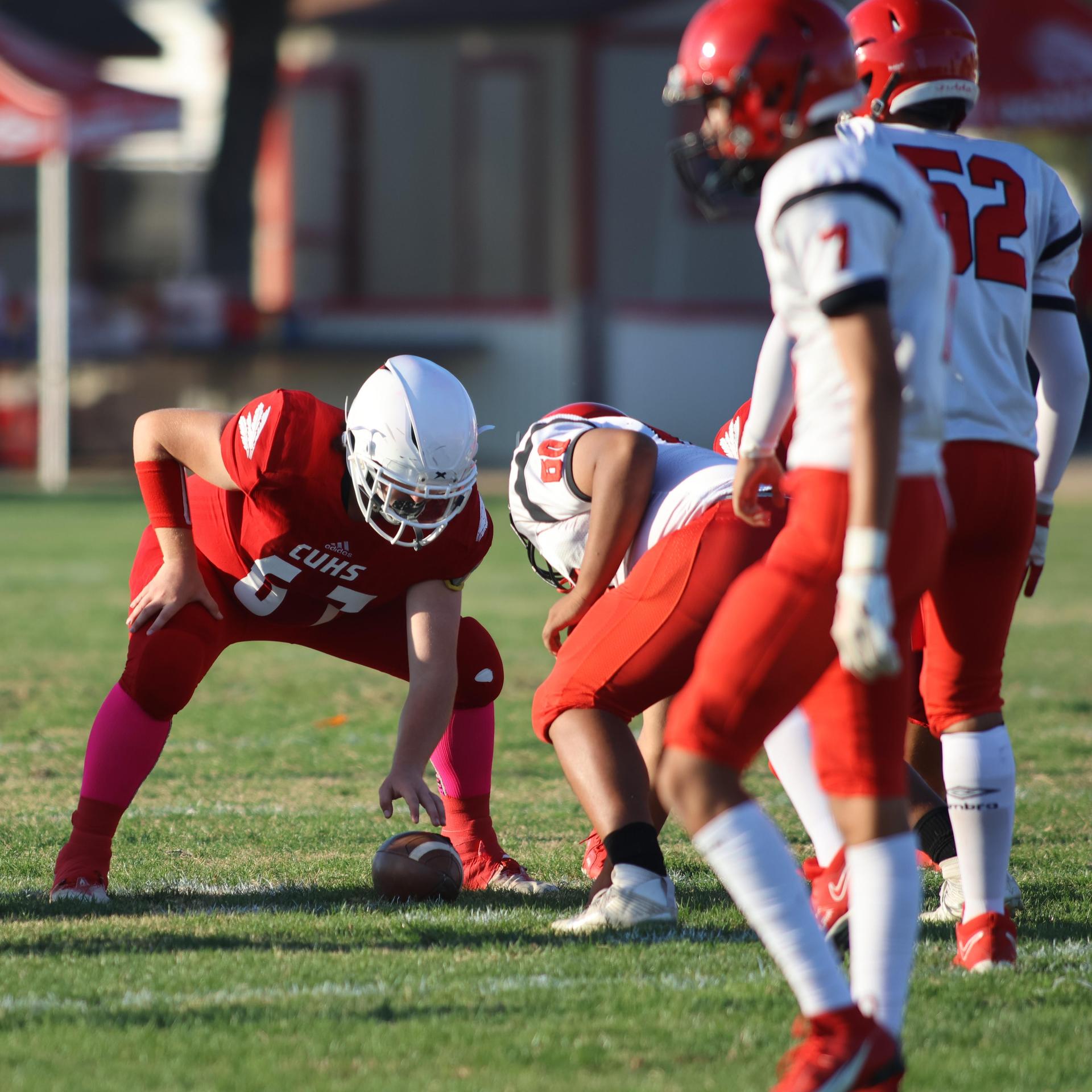 junior varsity football players in action against Fowler