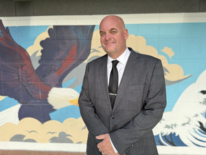 photo of Billy Wilson in front of Valley Vista High School mural