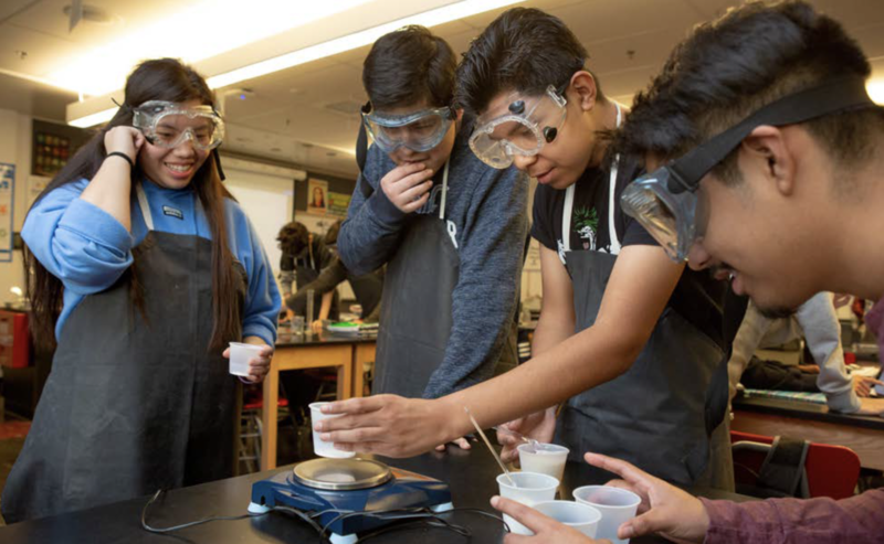 four students conduct science project