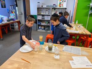 Two boys complete water experiments in STEAM