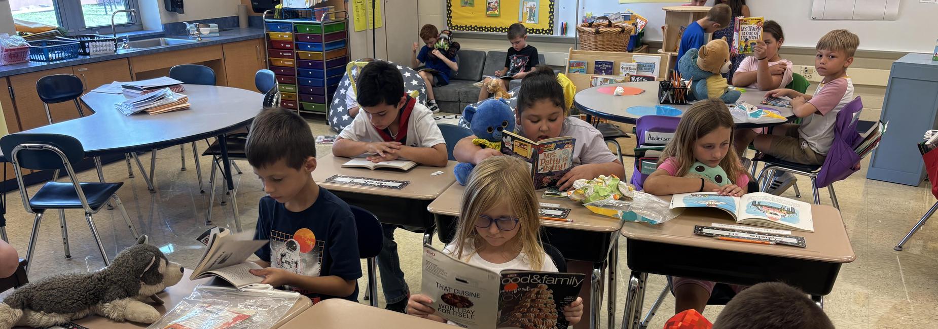 students reading to their stuffed animals