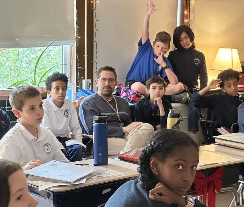 Mr. O'Connor teaches a pensive group of 5th graders about American History. At the time this photo was taken, students were analyzing a painting of 