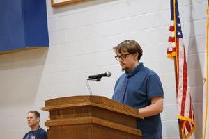 A student reads the Governor's Memorial Day Proclamation