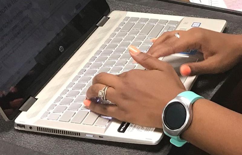 Teacher typing on a computer photo