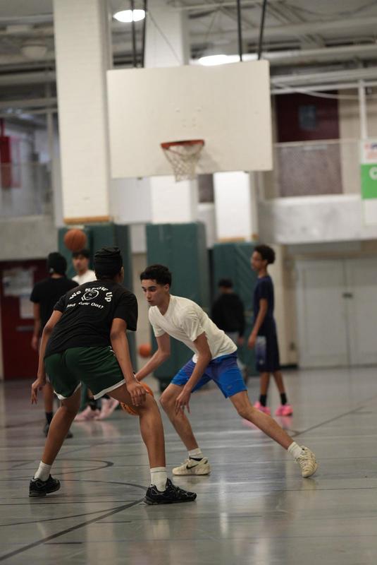 A basketball game in progress with players on the court.