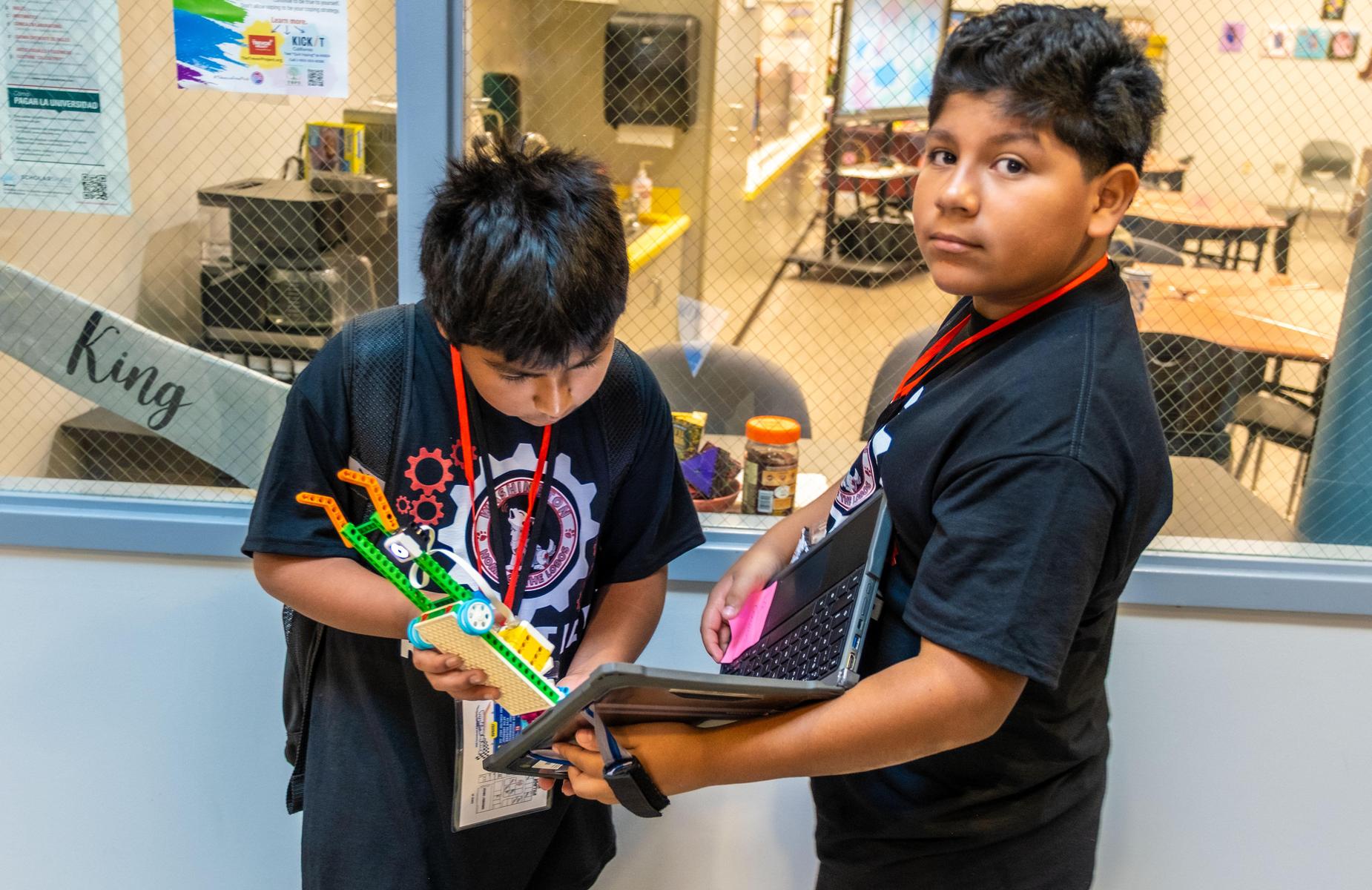 students work on alego robot while programming code