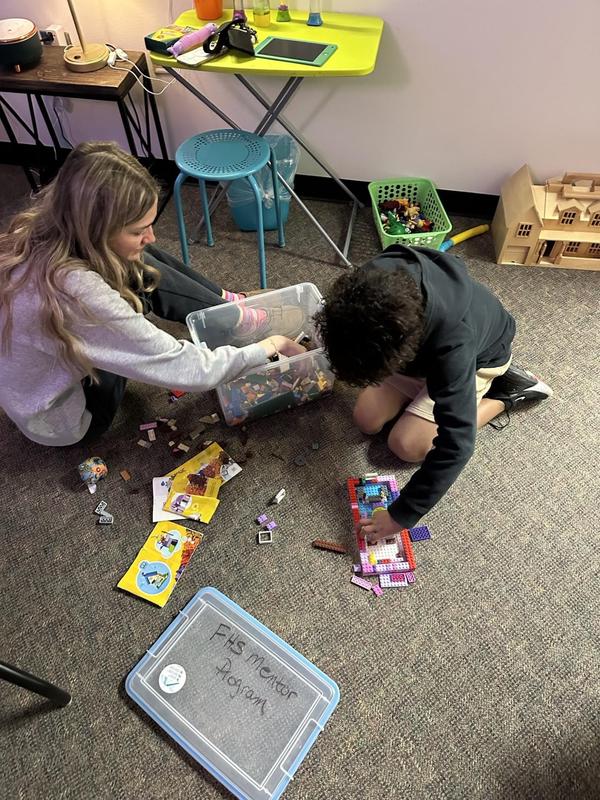 Current FHS mentor building with legos with one of their mentees.