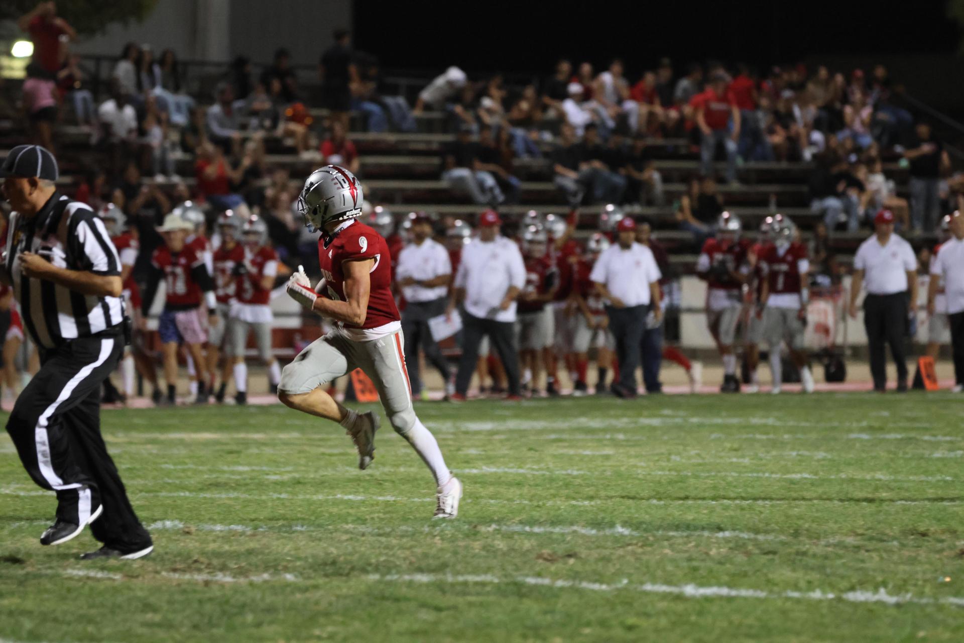 Varsity football players in action against Parlier 51