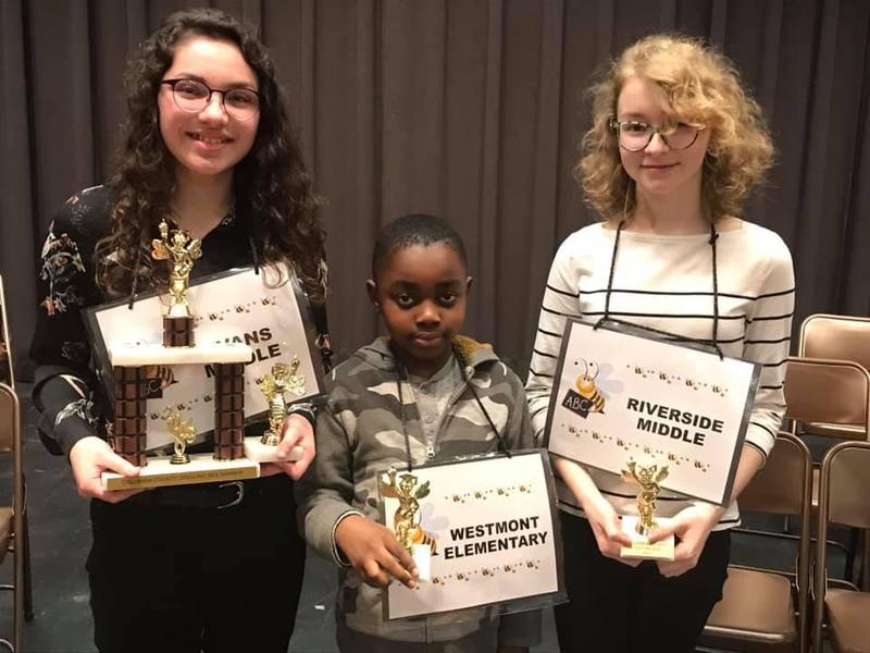 Winner, runner up and 3rd place Columbia County School District Spelling Bee winners holding trophies and certificates