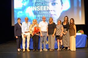 Group of eight people on a stage