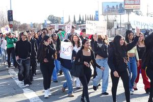 Students cross Hesperian Avenue as they join an anti-ICE protest.